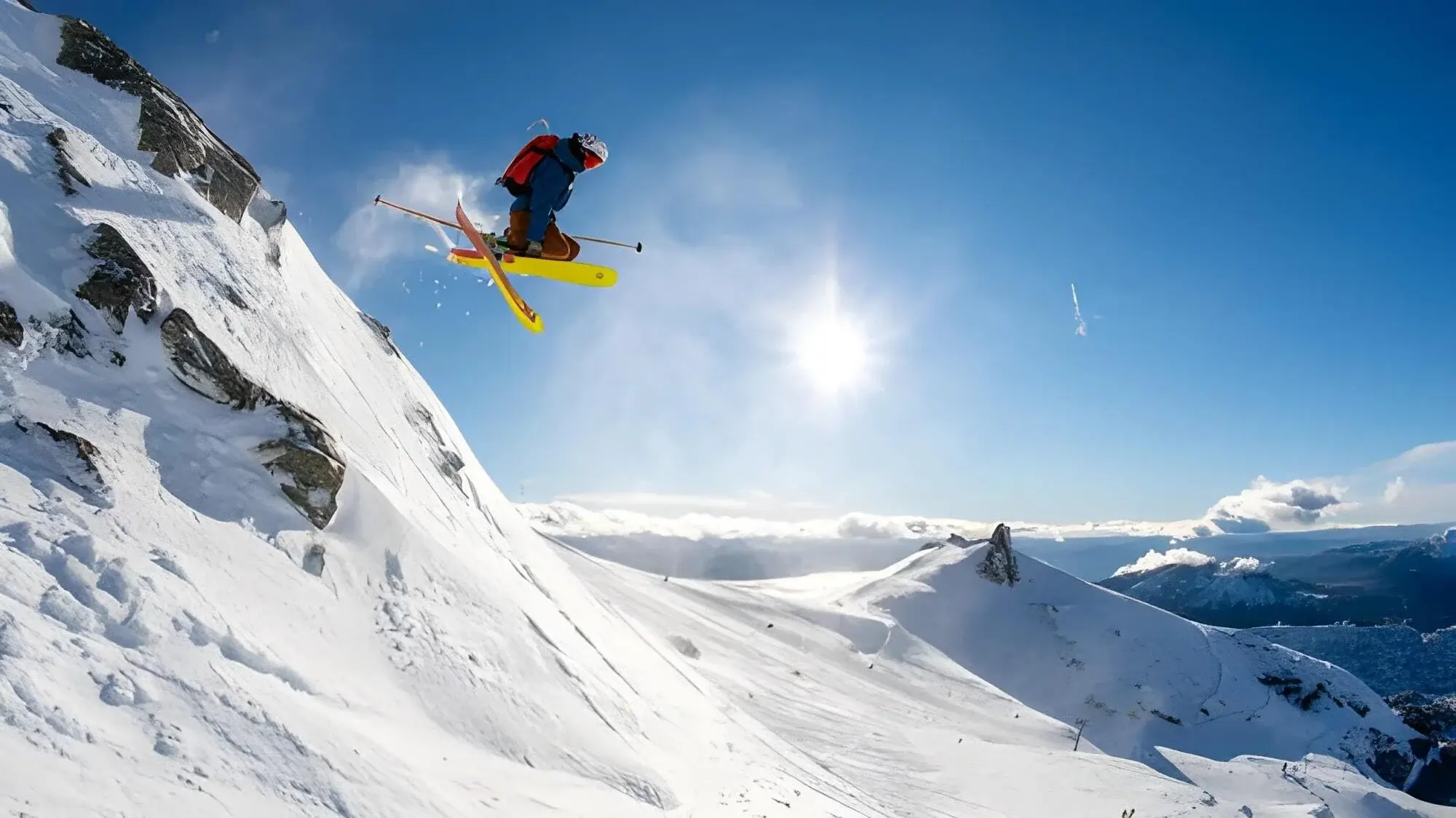 skier jumping off a cliff in the backcountry of patagonia